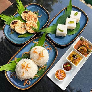 A Sri Lankan breakfast at Amber Poolside: hoppers, string hoppers, kiribath and small bowls of curry and sambol.