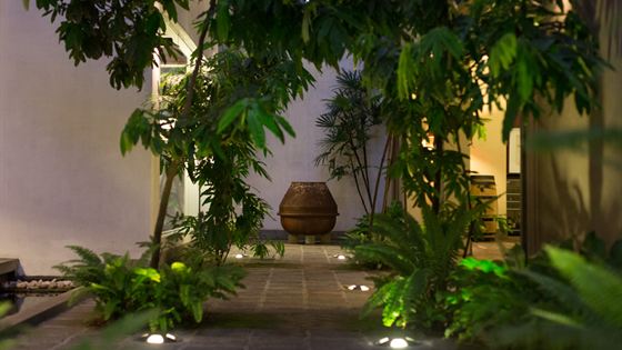 An old cement mixer turned into a fountain in a planted corner of the private courtyard at Colombo Court.
