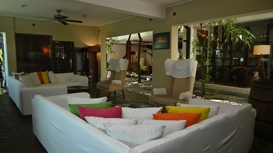 A long low sofa and lamps in a lounge at Colombo Court, a place to sit with a pot of tea.