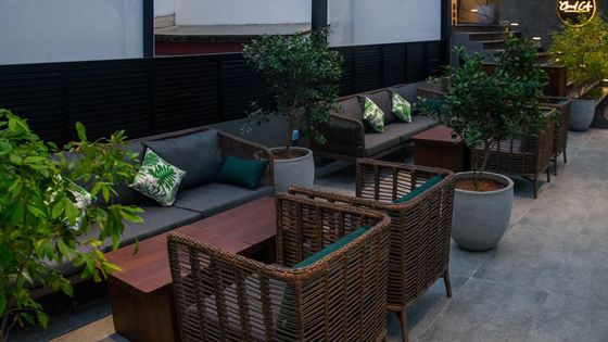Rooftop seating at Colombo Court with planted beds and the buildings of Colombo 3 beyond.