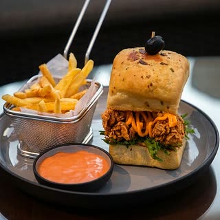 The Cloud burger with a basket of fries and a dip at Cloud Café & Bar.