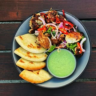Turkish seekh kebab with flatbread and a green chutney at Cloud Café & Bar.