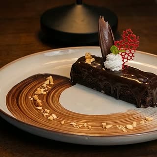 Brownie fantasy, a chocolate brownie plated with cream and a chocolate garnish at Cloud Café & Bar.