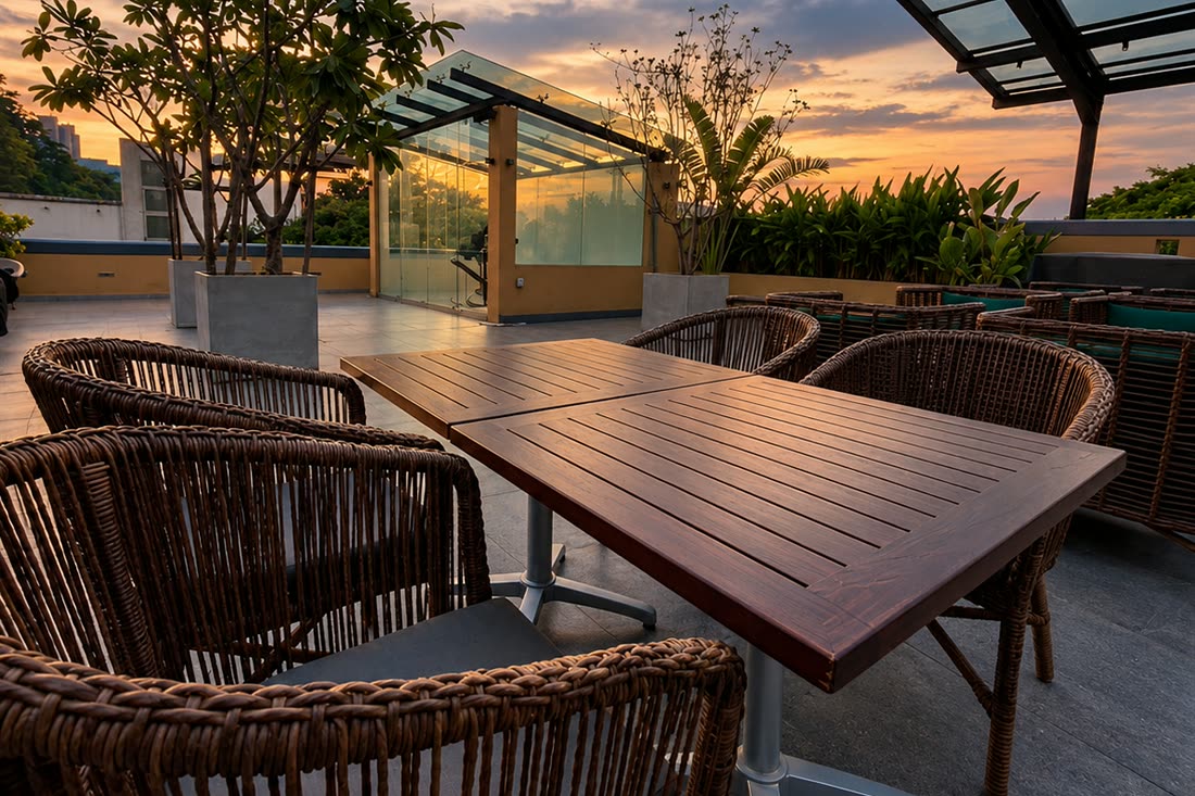 The rooftop at Cloud Caf&eacute; & Bar by day, the glass roof open to the sky over the long tables.