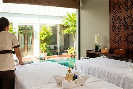 A therapist looking out to the plunge pool from the double treatment room at The Court Spa.